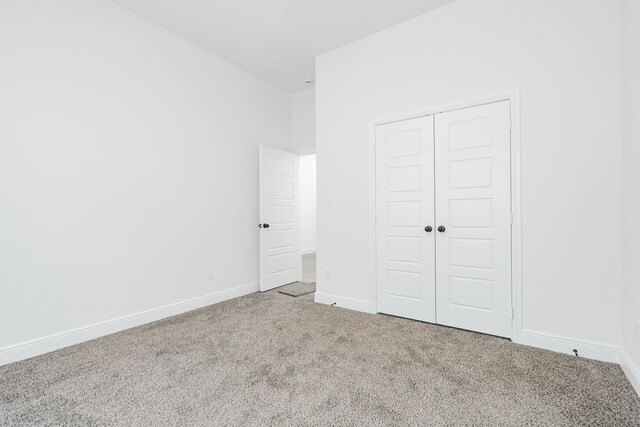 4507 Metropolitan Ave, Dallas, TX 75210 - unfurnished bedroom featuring carpet flooring, a closet, and baseboards