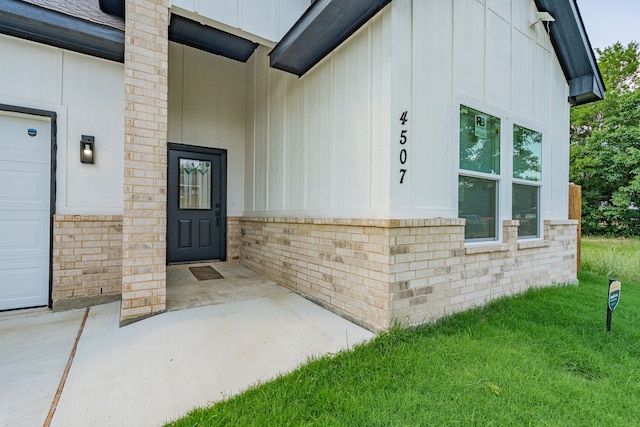 4507 Metropolitan Ave, Dallas, TX 75210 - entrance to property with board and batten siding, a lawn, and brick siding