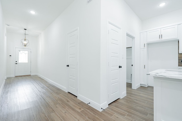 4507 Metropolitan Ave, Dallas, TX 75210 - hall with light wood-type flooring, baseboards, recessed lighting, and a chandelier