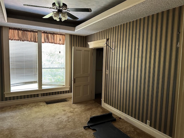 305 Quitman St, Pittsburg, TX 75686 - workout room with a raised ceiling, a ceiling fan, carpet, and baseboards