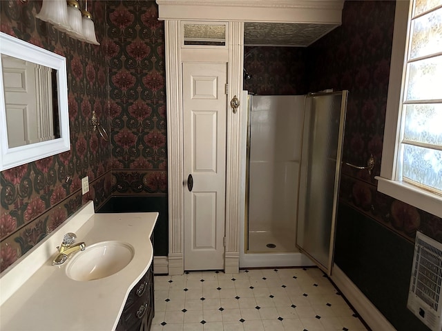 305 Quitman St, Pittsburg, TX 75686 - full bathroom featuring a shower stall, vanity, wallpapered walls, baseboards, and heating unit