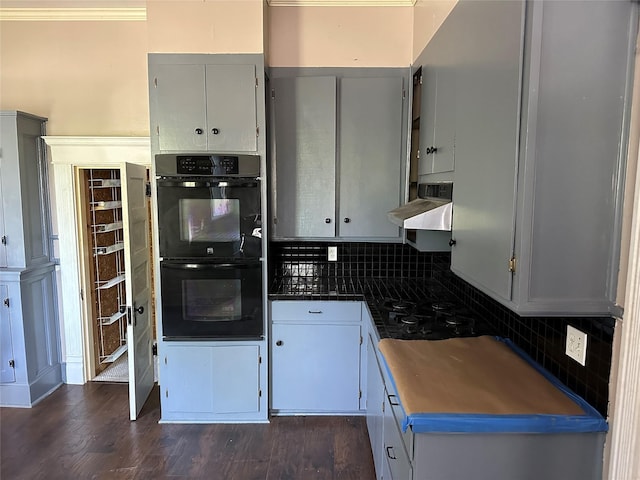 305 Quitman St, Pittsburg, TX 75686 - kitchen with black appliances, decorative backsplash, dark countertops, range hood, and gray cabinets