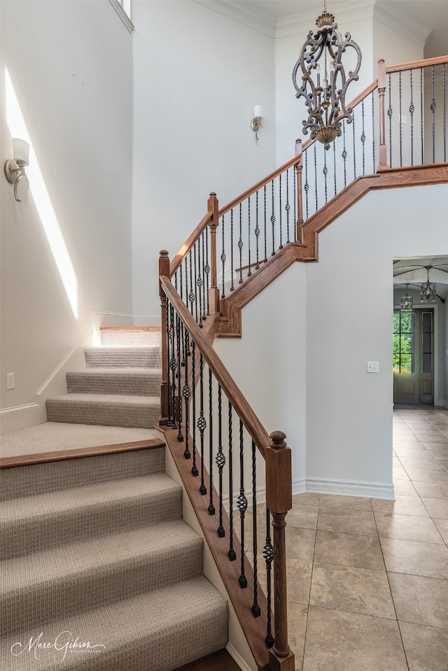187 Waters Edge Dr, Shreveport, LA 71106 - stairs featuring a chandelier, crown molding, a high ceiling, baseboards, and tile patterned floors