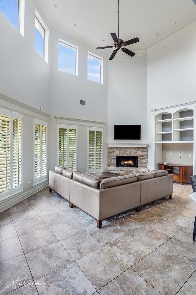 187 Waters Edge Dr, Shreveport, LA 71106 - living room with a towering ceiling, ornamental molding, a fireplace, ceiling fan, and baseboards