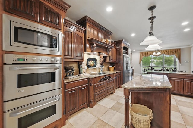 175 Robnett Rd, Waxahachie, TX 75165 - kitchen with appliances with stainless steel finishes, recessed lighting, backsplash, a kitchen island, and decorative light fixtures