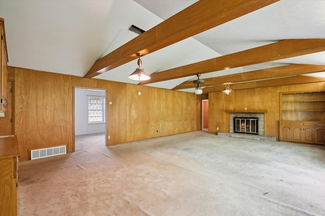 7200 Brooks Ave, Richland Hills, TX 76118 - unfurnished living room featuring wooden walls, carpet floors, ceiling fan, and a glass covered fireplace