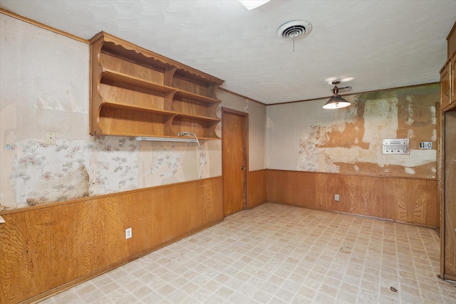 7200 Brooks Ave, Richland Hills, TX 76118 - empty room with a wainscoted wall, light flooring, wood walls, and wallpapered walls