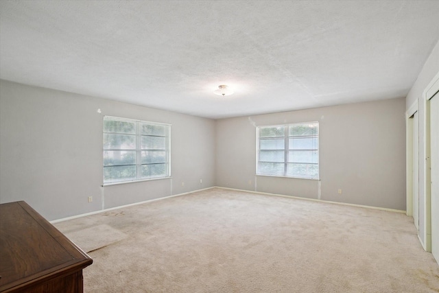 7200 Brooks Ave, Richland Hills, TX 76118 - empty room featuring light carpet, baseboards, and a textured ceiling