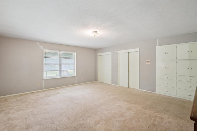 7200 Brooks Ave, Richland Hills, TX 76118 - unfurnished bedroom with two closets, carpet floors, and baseboards