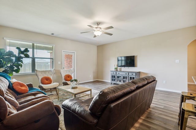 203 Lake Rdg, Princeton, TX 75407 - living room with arched walkways, a ceiling fan, wood finished floors, and baseboards