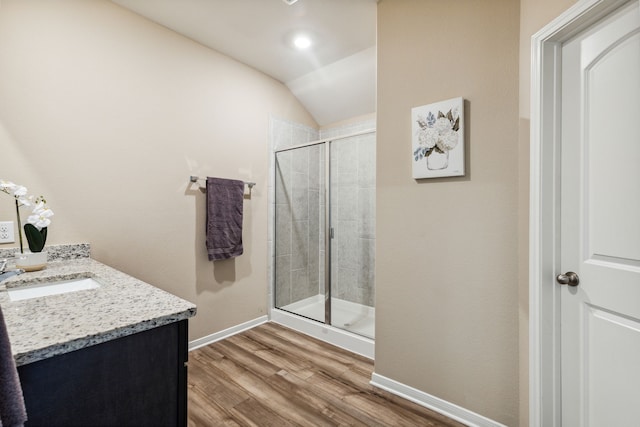 203 Lake Rdg, Princeton, TX 75407 - full bathroom with vanity, baseboards, a stall shower, wood finished floors, and vaulted ceiling