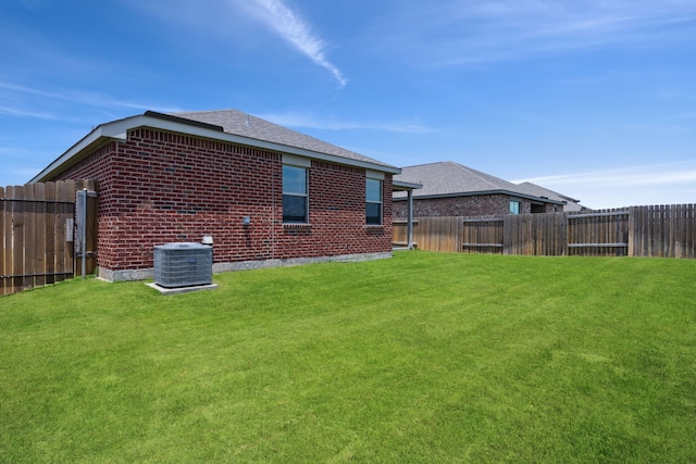 203 Lake Rdg, Princeton, TX 75407 - rear view of property featuring brick siding, central AC unit, and a shingled roof