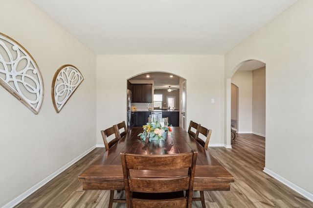 203 Lake Rdg, Princeton, TX 75407 - dining room with wood finished floors, arched walkways, and baseboards