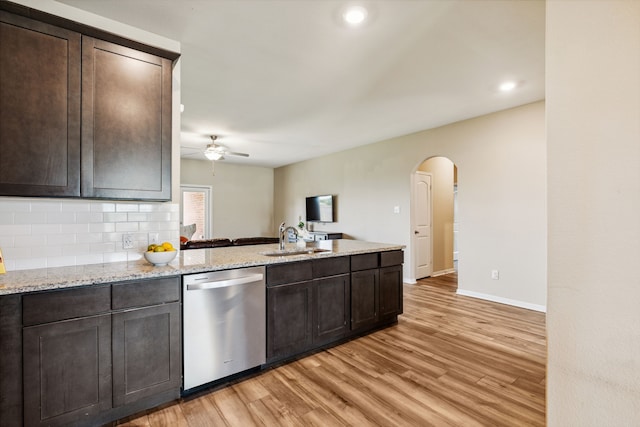 203 Lake Rdg, Princeton, TX 75407 - kitchen with stainless steel dishwasher, a sink, arched walkways, light wood finished floors, and dark brown cabinetry