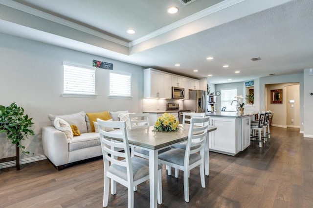 7812 Gulf Breeze Ln, Frisco, TX 75036 - dining room featuring crown molding, plenty of natural light, recessed lighting, dark wood finished floors, and baseboards