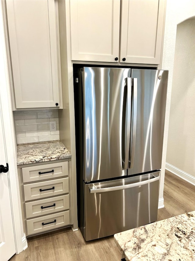 358 Frederick Dr, Robinson, TX 76706 - kitchen with freestanding refrigerator, light wood-type flooring, and backsplash