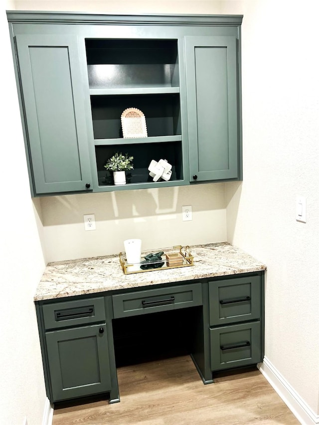 358 Frederick Dr, Robinson, TX 76706 - bar area featuring built in study area, baseboards, and light wood finished floors
