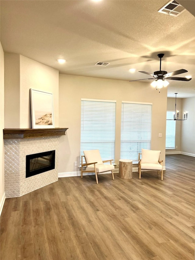 358 Frederick Dr, Robinson, TX 76706 - sitting room featuring wood finished floors, a tiled fireplace, baseboards, ceiling fan, and recessed lighting
