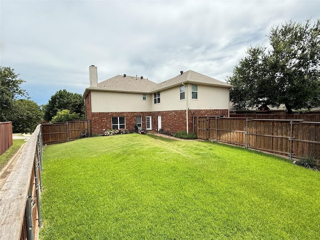 796 Ridge Rd W, Rockwall, TX 75087 - back of property with brick siding, a chimney, and a fenced backyard