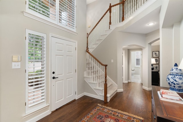 1405 San Mateo Dr, Allen, TX 75013 - entryway with arched walkways, wood finished floors, stairway, baseboards, and a high ceiling