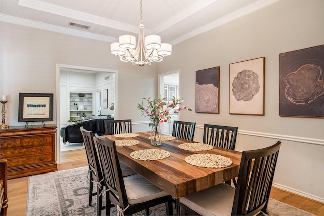 6737 Lake Shore Dr, Garland, TX 75044 - dining room with light wood finished floors, a chandelier, and crown molding