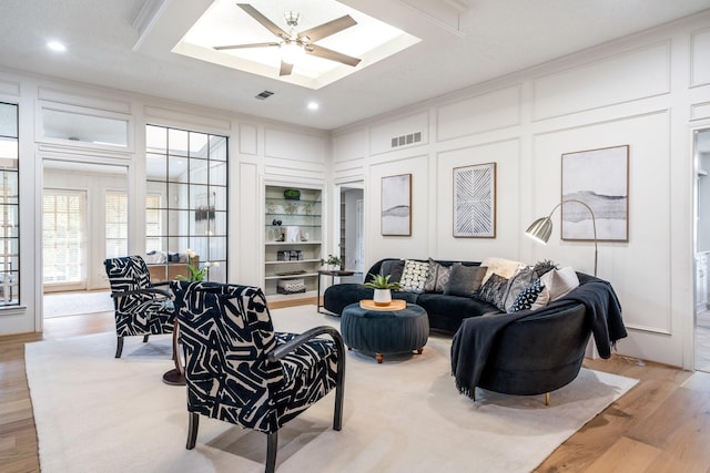 6737 Lake Shore Dr, Garland, TX 75044 - living room with a decorative wall, light wood-style floors, recessed lighting, a skylight, and a ceiling fan