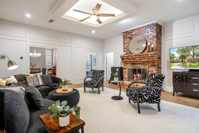 6737 Lake Shore Dr, Garland, TX 75044 - living room with a decorative wall, light wood finished floors, a brick fireplace, ceiling fan, and recessed lighting