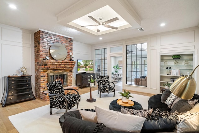 6737 Lake Shore Dr, Garland, TX 75044 - living room with wood finished floors, a fireplace, a decorative wall, a skylight, and recessed lighting