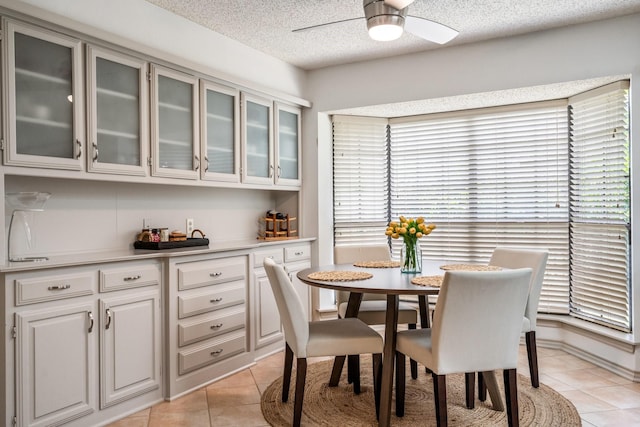 6737 Lake Shore Dr, Garland, TX 75044 - dining room featuring light tile patterned floors, a ceiling fan, and a textured ceiling