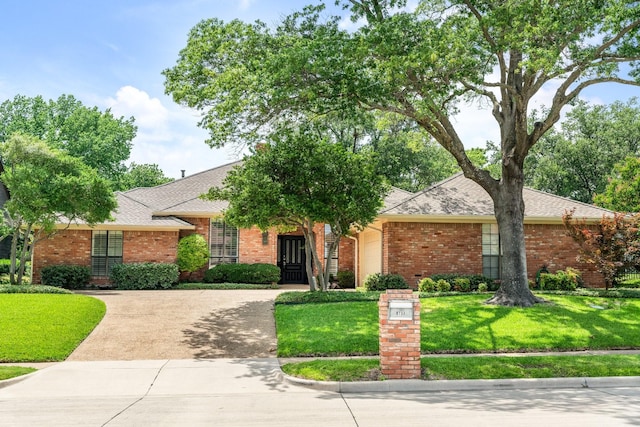 6737 Lake Shore Dr, Garland, TX 75044 - view of front of property featuring concrete driveway, a garage, brick siding, and a front yard