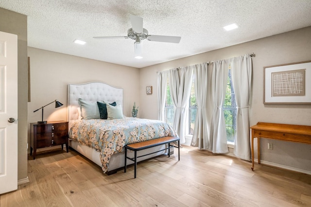 6737 Lake Shore Dr, Garland, TX 75044 - bedroom featuring wood finished floors, a textured ceiling, a ceiling fan, and access to outside
