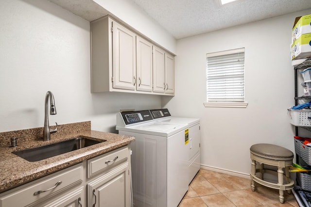 6737 Lake Shore Dr, Garland, TX 75044 - laundry area with washer and dryer, cabinet space, light tile patterned flooring, and a textured ceiling