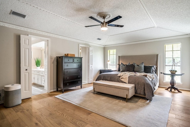 6737 Lake Shore Dr, Garland, TX 75044 - bedroom with wood finished floors, a textured ceiling, crown molding, ensuite bathroom, and ceiling fan