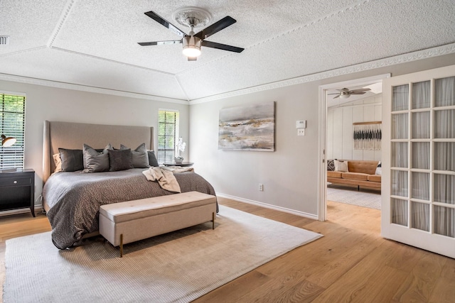 6737 Lake Shore Dr, Garland, TX 75044 - bedroom featuring wood finished floors, ornamental molding, a textured ceiling, and a ceiling fan