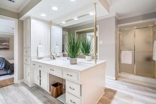 6737 Lake Shore Dr, Garland, TX 75044 - bathroom featuring vanity, ornamental molding, a stall shower, recessed lighting, and wood finished floors