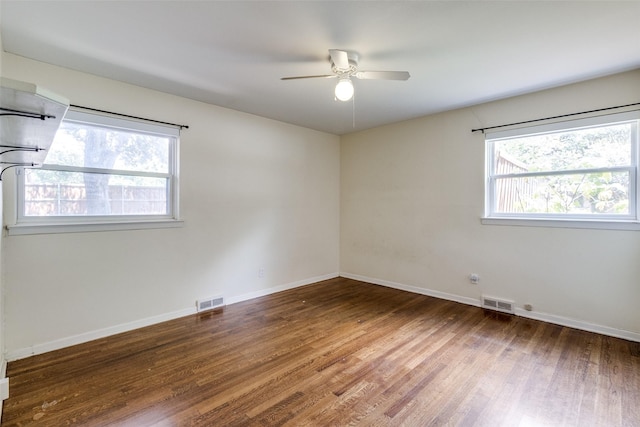 3635 Merrell Rd, Dallas, TX 75229 - spare room with healthy amount of natural light, a ceiling fan, wood finished floors, and baseboards