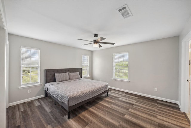 2144 County Road 4535, Whitewright, TX 75491 - bedroom with baseboards, dark wood-style flooring, and a ceiling fan
