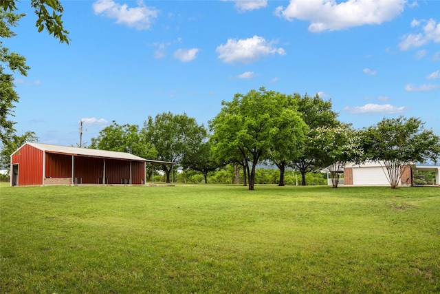 2144 County Road 4535, Whitewright, TX 75491 - view of grassy yard featuring a pole building, a garage, and an outdoor structure