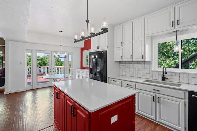7317 E Fm 917, Alvarado, TX 76009 - kitchen featuring black fridge, a sink, light countertops, backsplash, and a chandelier