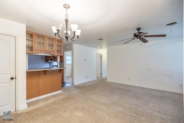25 Spears Cir, Abilene, TX 79601 - kitchen with light carpet, a chandelier, glass insert cabinets, a ceiling fan, and a kitchen breakfast bar
