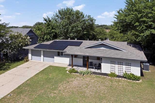 5405 Westhaven Dr, Fort Worth, TX 76132 - view of front of home with a garage, central AC, a front yard, and solar panels