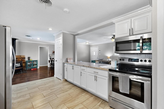 5405 Westhaven Dr, Fort Worth, TX 76132 - kitchen with stainless steel appliances, crown molding, white cabinetry, recessed lighting, and a peninsula