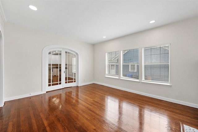 1608 N 17th St, Waco, TX 76707 - empty room featuring arched walkways, wood finished floors, baseboards, and recessed lighting