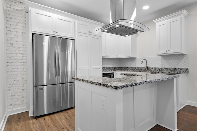 1608 N 17th St, Waco, TX 76707 - kitchen featuring freestanding refrigerator, island exhaust hood, wood finished floors, baseboards, and recessed lighting