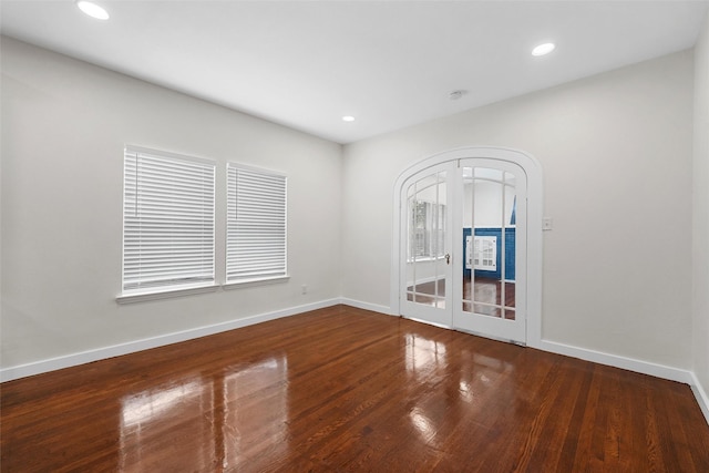 1608 N 17th St, Waco, TX 76707 - spare room featuring wood finished floors, baseboards, recessed lighting, and french doors