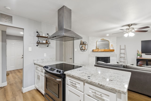 559 Bell Dr, Allen, TX 75002 - kitchen with island range hood, stainless steel electric range oven, white cabinets, and open floor plan