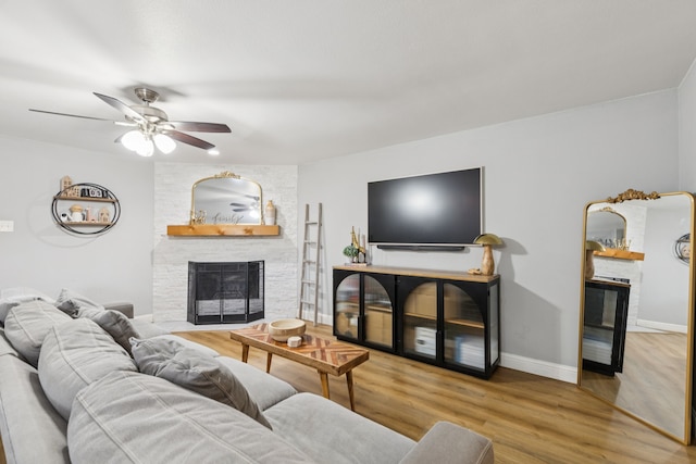 559 Bell Dr, Allen, TX 75002 - living room with a fireplace, wood finished floors, ceiling fan, and baseboards