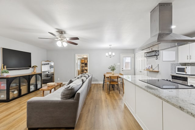 559 Bell Dr, Allen, TX 75002 - living area with light wood finished floors, ceiling fan, a chandelier, and baseboards