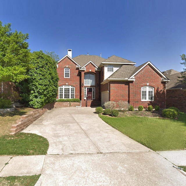 2505 Links Dr, Plano, TX 75093 - traditional-style home with brick siding, driveway, a chimney, and a front yard