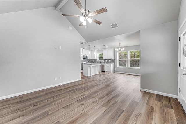 915 Comanche Cove Dr, Granbury, TX 76048 - unfurnished living room with a ceiling fan, a chandelier, beam ceiling, light wood-type flooring, and high vaulted ceiling